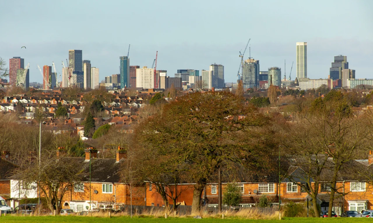 Birmingham city centre skyline seen over houses in Yardley